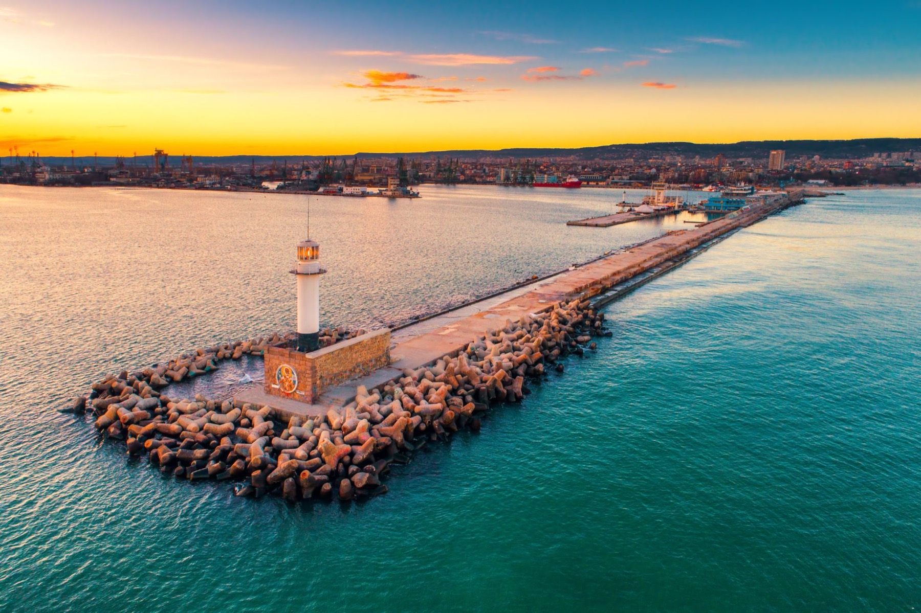 Varna lighthouse and breakwater at sunset